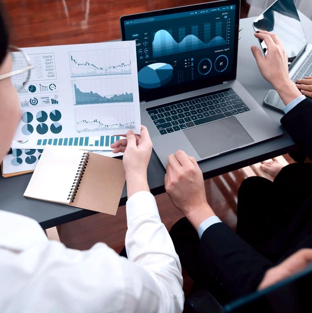Digital marketing team analyzing data on multiple screens